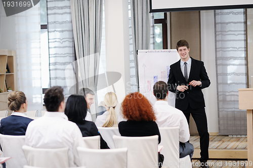 Image of Young  business man giving a presentation on conference