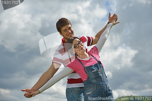 Image of Portrait of romantic young couple smiling together outdoor