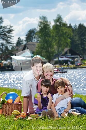 Image of Happy family playing together in a picnic outdoors