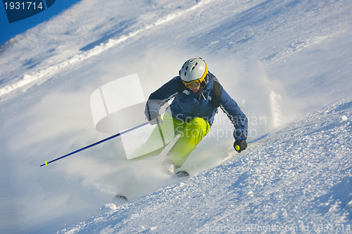 Image of skiing on fresh snow at winter season at beautiful sunny day