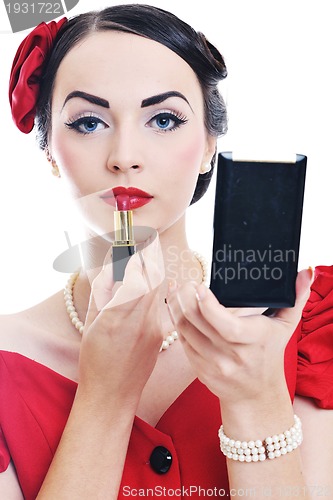 Image of beautiful young woman applying makeup