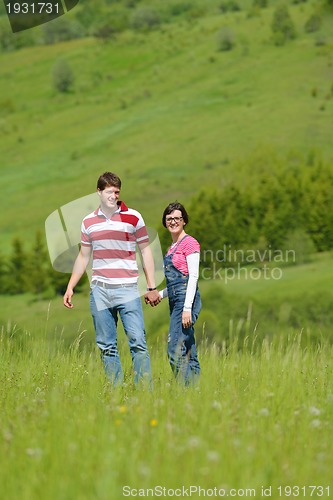 Image of Portrait of romantic young couple smiling together outdoor