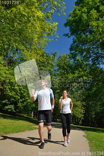 Image of Young couple jogging at morning