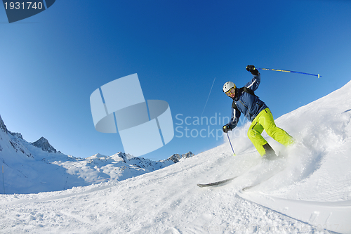 Image of skiing on fresh snow at winter season at beautiful sunny day