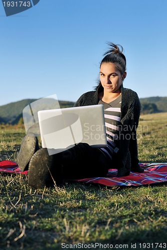 Image of young teen girl work on laptop outdoor