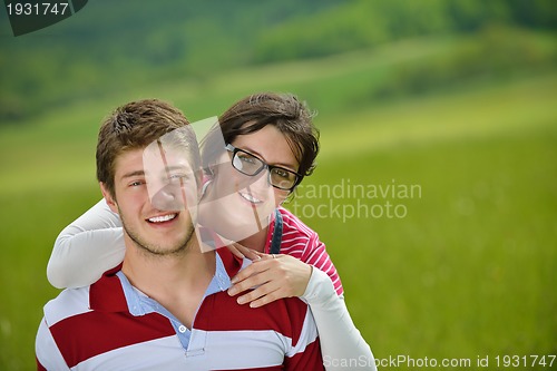 Image of Portrait of romantic young couple smiling together outdoor