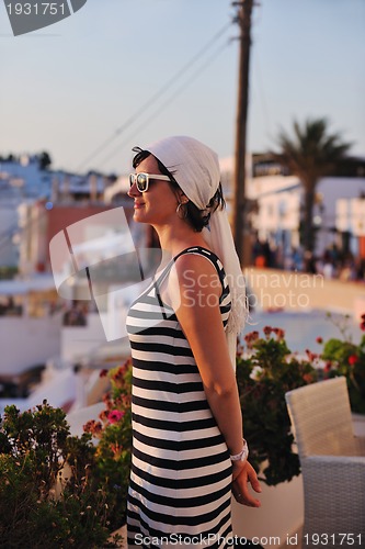 Image of Greek woman on the streets of Oia, Santorini, Greece