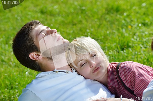 Image of Portrait of romantic young couple smiling together outdoor