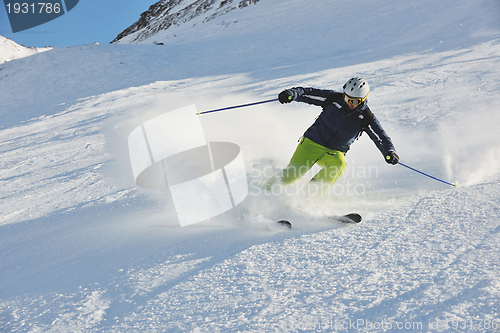 Image of skiing on fresh snow at winter season at beautiful sunny day