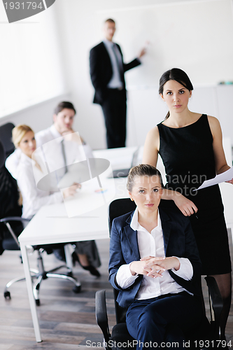 Image of business woman with her staff in background