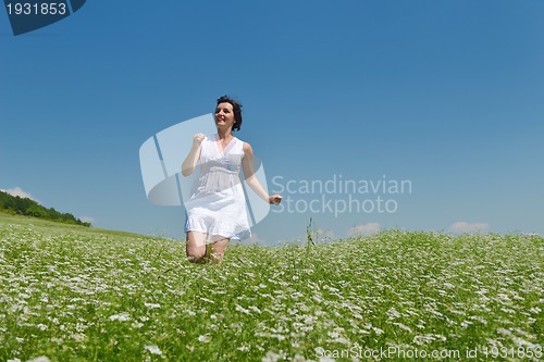 Image of Young happy woman in green field