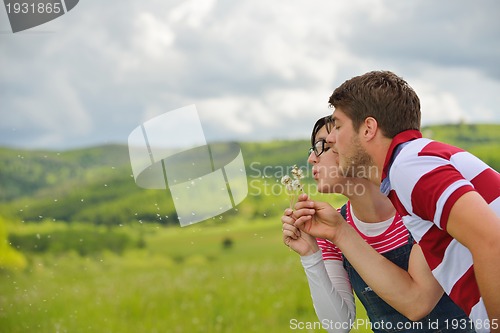 Image of Portrait of romantic young couple smiling together outdoor