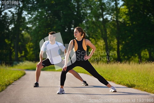 Image of Couple doing stretching exercise  after jogging