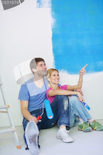 Image of happy young cople relaxing after painting in new home
