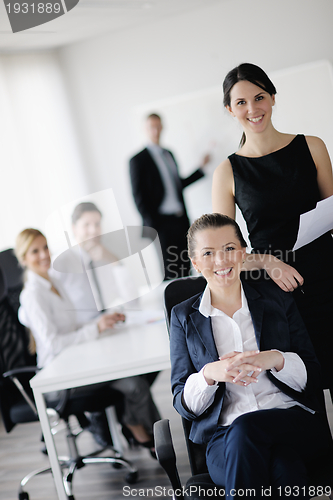 Image of business woman with her staff in background