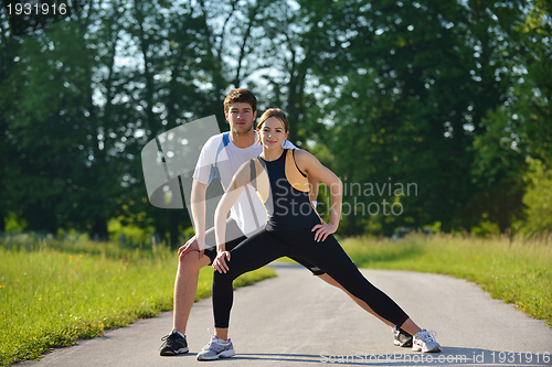 Image of Couple doing stretching exercise  after jogging