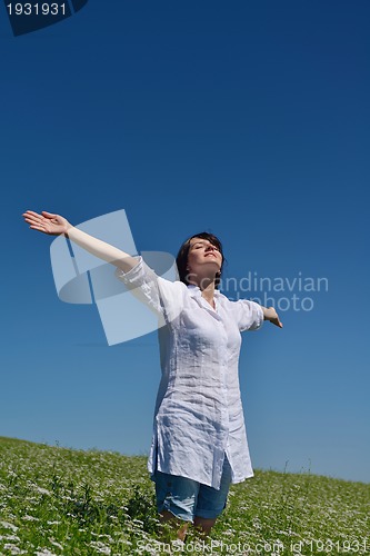 Image of young woman in wheat field at summer