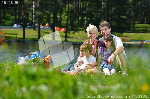 Image of Happy family playing together in a picnic outdoors