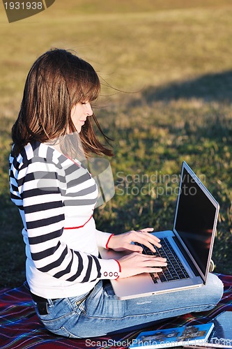 Image of young teen girl work on laptop outdoor