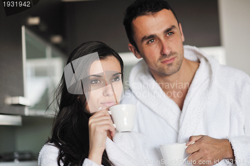 Image of Young love couple taking fresh morning cup of coffee