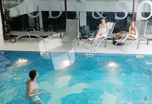Image of young people group at spa swimming pool