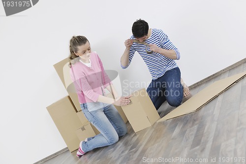 Image of Young couple moving in new home