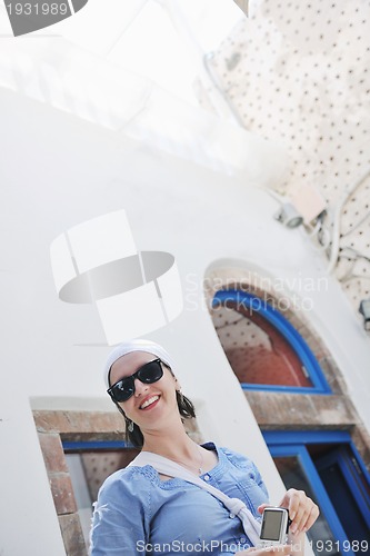 Image of Greek woman on the streets of Oia, Santorini, Greece