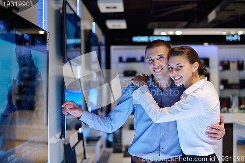 Image of Young couple in consumer electronics store