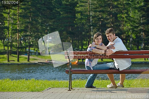 Image of Portrait of romantic young couple smiling together outdoor