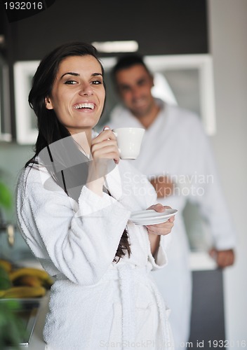 Image of Young love couple taking fresh morning cup of coffee