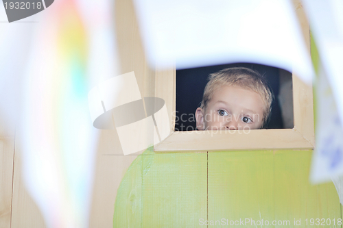 Image of happy child in a window