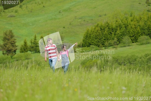 Image of Portrait of romantic young couple smiling together outdoor