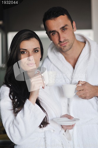 Image of Young love couple taking fresh morning cup of coffee