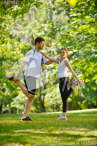 Image of Couple doing stretching exercise  after jogging