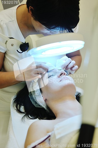 Image of woman with facial mask in cosmetic studio