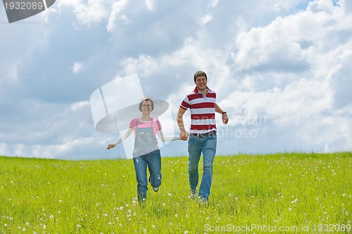 Image of Portrait of romantic young couple smiling together outdoor