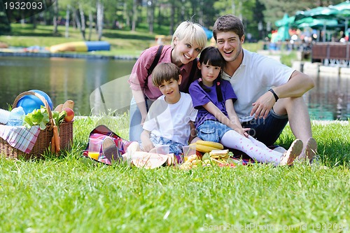 Image of Happy family playing together in a picnic outdoors