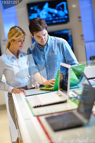 Image of Young couple in consumer electronics store