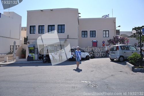 Image of Greek woman on the streets of Oia, Santorini, Greece