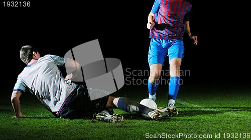 Image of football players in competition for the ball