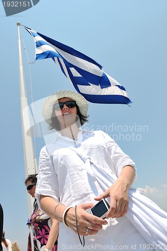 Image of Greek woman on the streets of Oia, Santorini, Greece