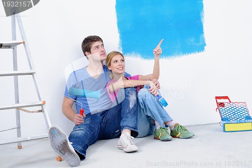 Image of happy young cople relaxing after painting in new home