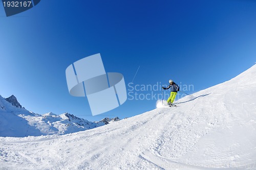 Image of skiing on fresh snow at winter season at beautiful sunny day