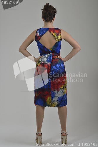 Image of elegant woman in fashionable dress posing in the studio
