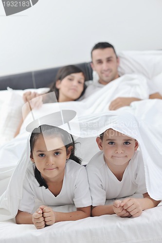 Image of happy young Family in their bedroom