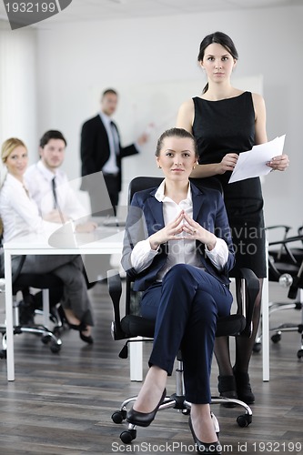 Image of business woman with her staff in background