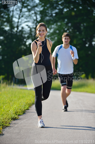 Image of Young couple jogging at morning