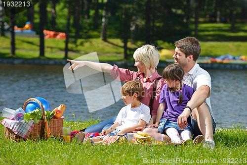Image of Happy family playing together in a picnic outdoors