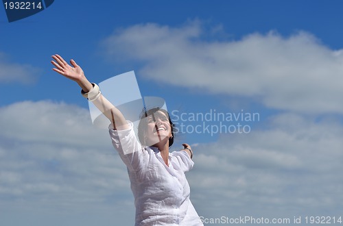 Image of happy young woman with spreading arms to sky