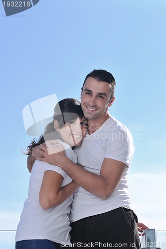 Image of couple relaxing on balcony